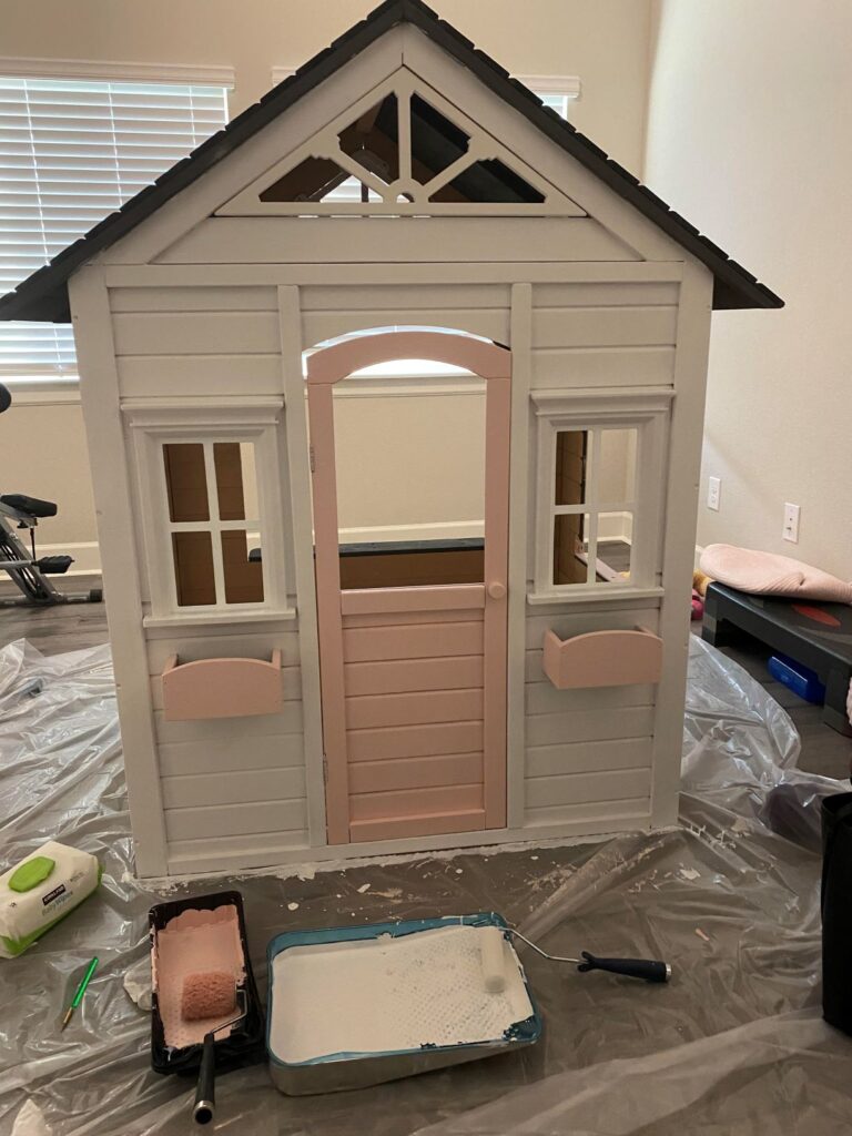 painting the wooden playhouse. I now know to paint the playhouse before assembled. 