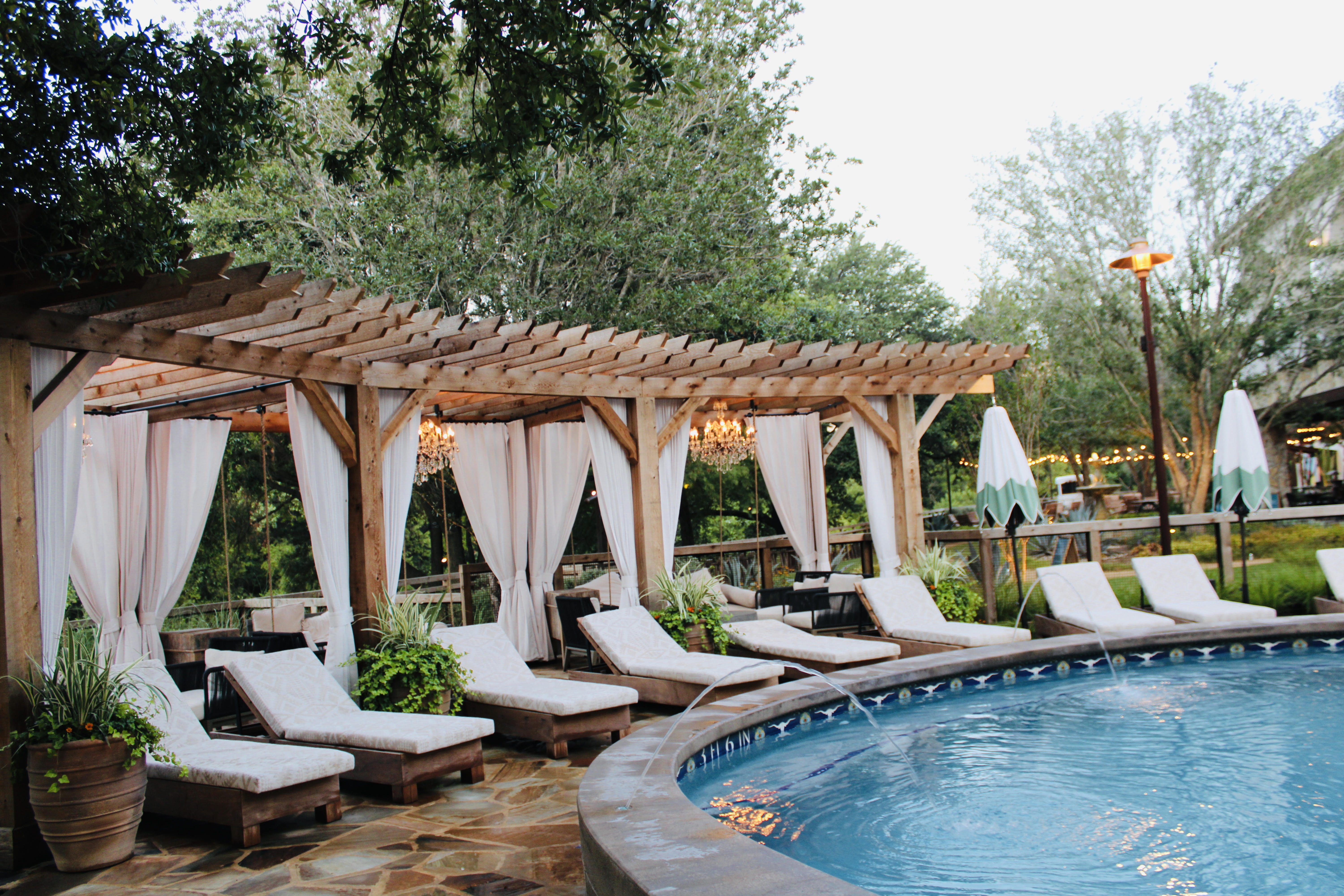 The pool with cabanas and crystal bronze chandeliers.