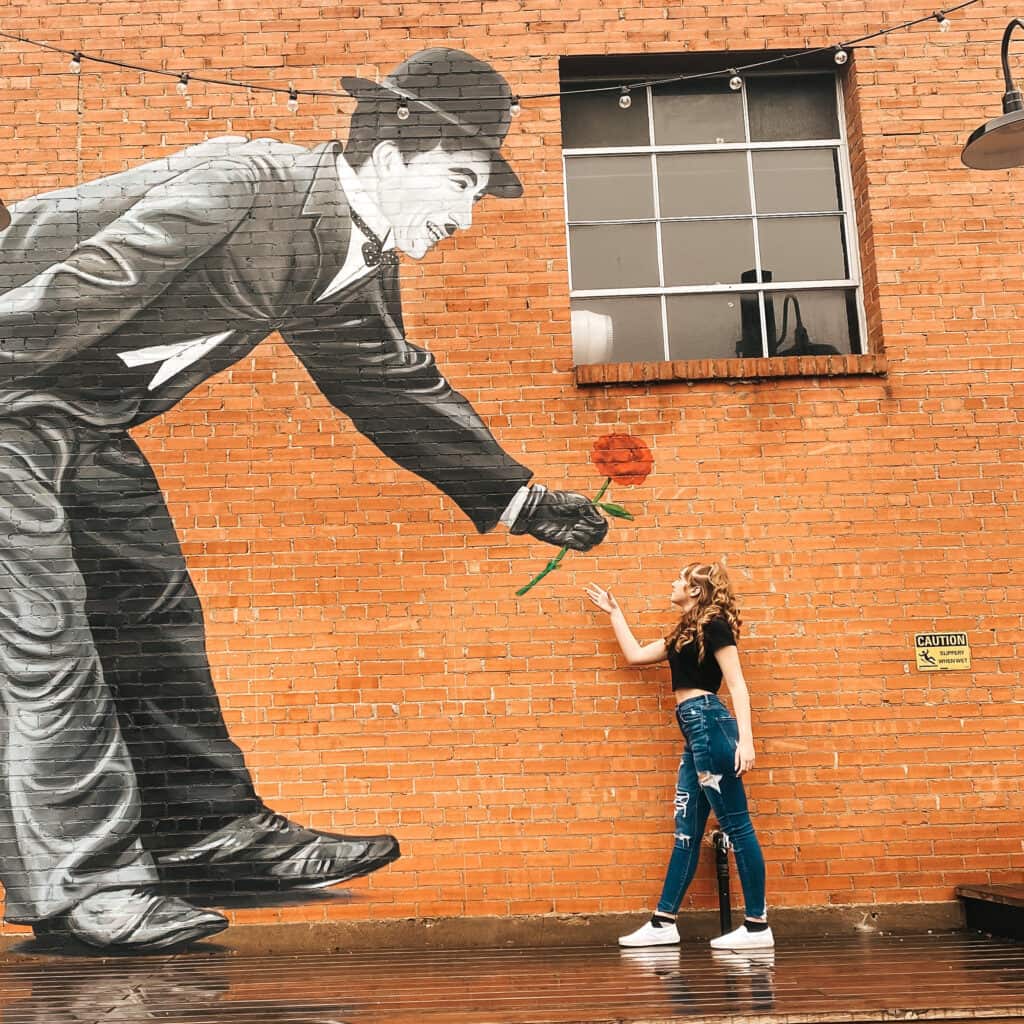 Our favorite mural of Charlie Chapin behind Talking Out of Turn and Joy Macarons in Oak Cliff