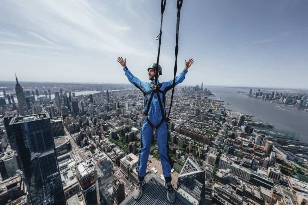 Hanging over the edge of a skyscraper is definitely and unusual thing  to do in New York City